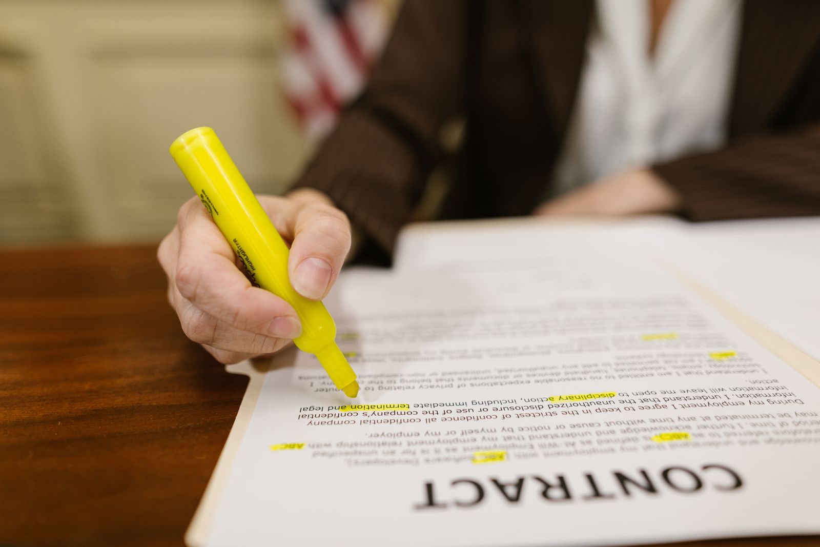 Highlighter marking the fine print on a printed contract